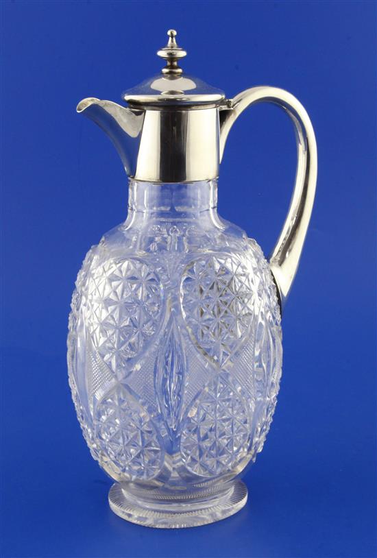 An Edwardian silver mounted cut glass claret jug by William Comyns, 11in.